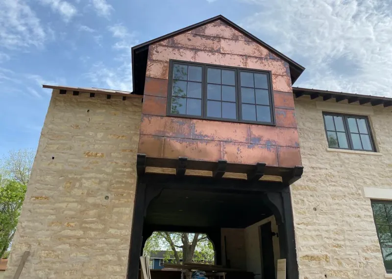 Copper metal panel facade on a stone building for Roof Repair in Lilburn