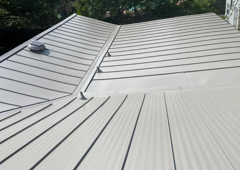 Solar attic fan installed on a metal roof for Roof Ventilation in Lilburn